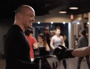 smiling student from our vancouver kickboxing group class